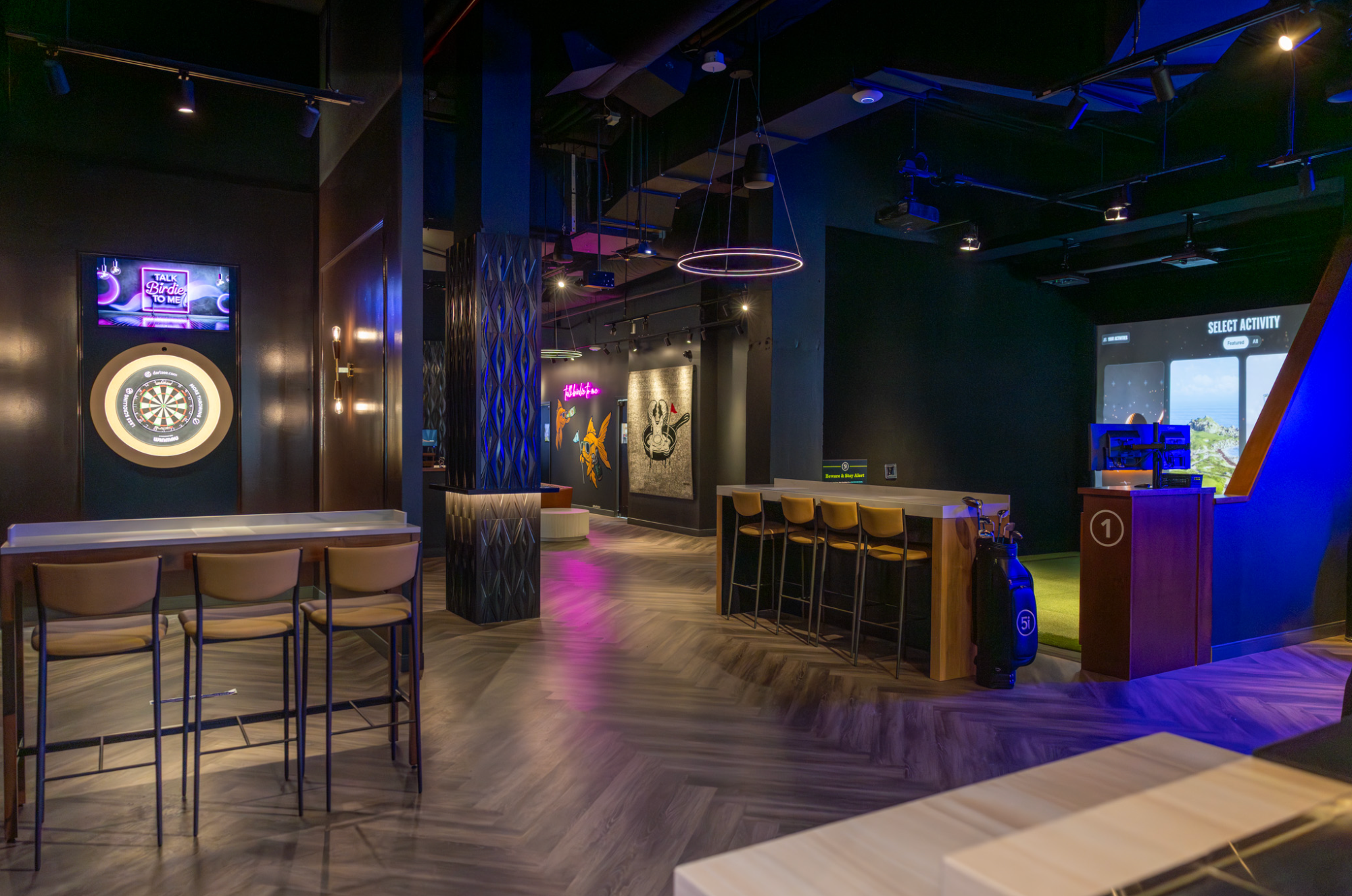 Five Iron Golf venue with lounge tables, darts and a simulator bay